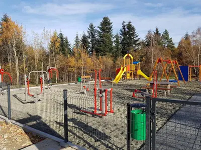a playground with a bunch of slides and swings at Gniewnik in Pcim