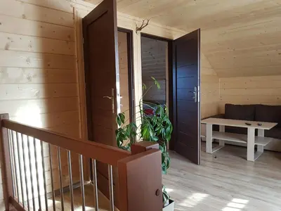 a wooden room with a staircase and a bench at Gniewnik in Pcim