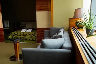 a living room with a couch and a bed at Młyn Jacka Hotel & Spa in Wadowice