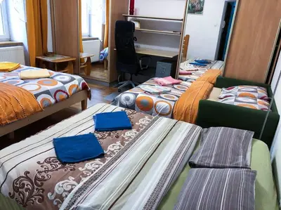 a room with three beds and a mirror at Sunny apartment. 5 minutes walk from Main Sqare. in Kraków
