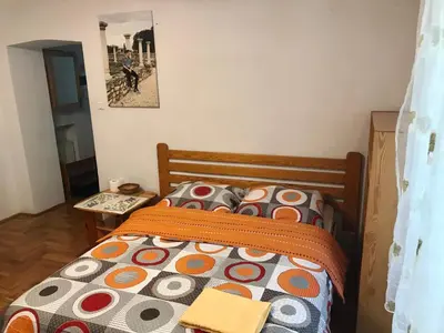 a bedroom with a bed with a colorful comforter at Sunny apartment. 5 minutes walk from Main Sqare. in Kraków