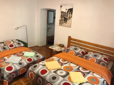 a bedroom with two beds and a table at Sunny apartment. 5 minutes walk from Main Sqare. in Kraków