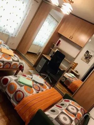 a small room with two beds and a desk at Sunny apartment. 5 minutes walk from Main Sqare. in Kraków