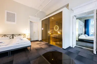 a bedroom with a bed and a glass wall at Home Aparthotel in Kraków