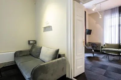 a living room with a couch and a chair at Home Aparthotel in Kraków