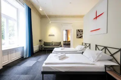 a room with two beds and a couch at Home Aparthotel in Kraków