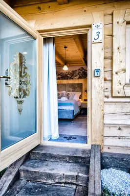 a door to a bedroom with a bed in it at Skansen Holiday in Cholerzyn