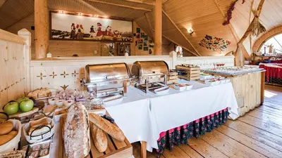 a kitchen with a table with bread and other foods at Skansen Holiday in Cholerzyn