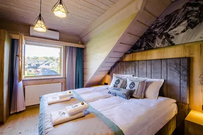 a bedroom with a large bed in a room at Skansen Holiday in Cholerzyn