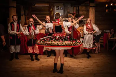 a group of people in traditional costumes with a woman in a large dress at Skansen Holiday in Cholerzyn