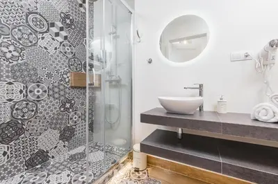 a bathroom with a sink and a shower at Agnes Apartments Old Town in Kraków