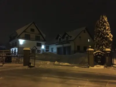 a group of houses in the snow at night at Silver Residence in Rabka
