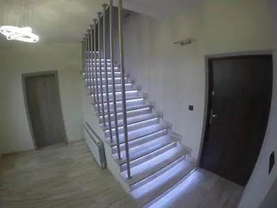 a staircase in a building with a wooden floor and a door at Silver Residence in Rabka