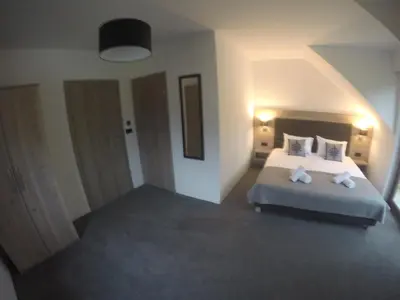 a bedroom with a bed with two pillows at Silver Residence in Rabka