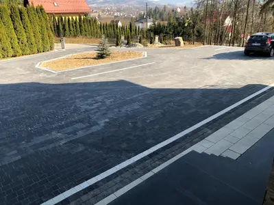 a parking lot with a car parked on the street at Silver Residence in Rabka
