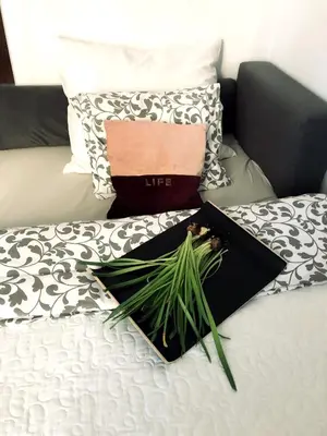 a bed with two pillows and a purse on it at Nico Apartments in Kraków