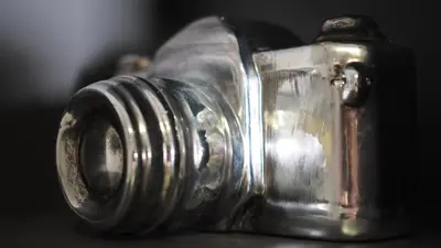 a close up of a silver camera on a table at Nico Apartments in Kraków