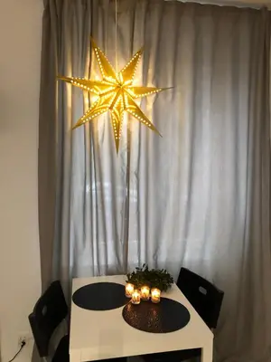 a table with a star hanging from a curtain at Nico Apartments in Kraków