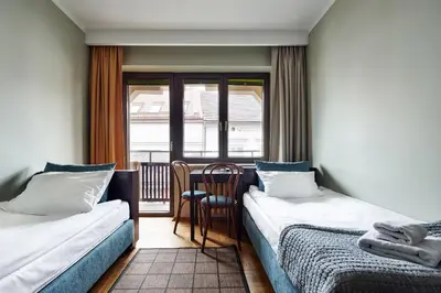 a bed in a room with a large window at Willa Pierrot in Oświęcim