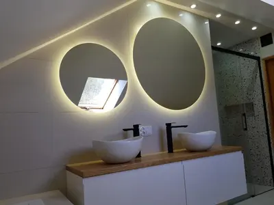two sinks on a counter in a bathroom with two mirrors at Na Stawach in Stryszów