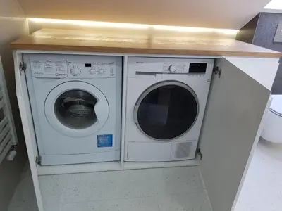 a washer and dryer under a counter in a room at Na Stawach in Stryszów