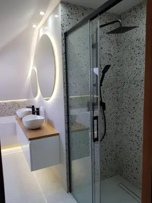 a bathroom with a glass shower and a sink at Na Stawach in Stryszów