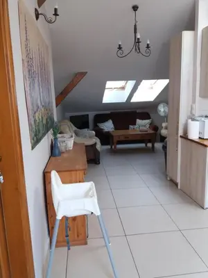 a white chair in a living room with skylights at Lawendowe Siedlisko in Zator