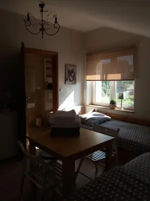 a room with a table and a bedroom with a bed at Lawendowe Siedlisko in Zator