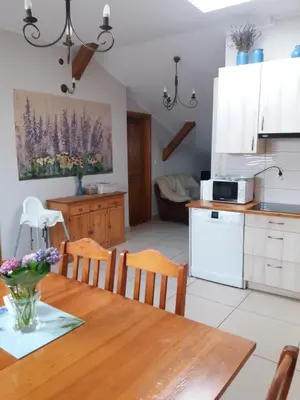 a kitchen and dining room with a table and chairs at Lawendowe Siedlisko in Zator