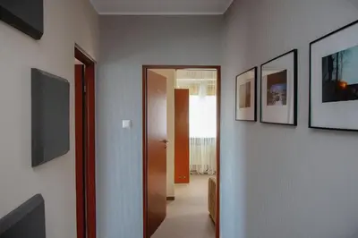 a hallway with pictures on the walls of a room at Villa Green in Oświęcim