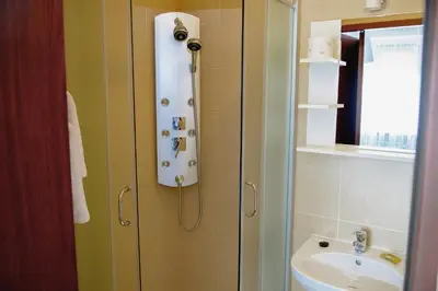 a bathroom with a shower and a sink at Villa Green in Oświęcim