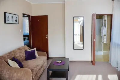 a living room with a couch and a table at Villa Green in Oświęcim