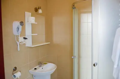 a bathroom with a toilet and a sink and a shower at Villa Green in Oświęcim
