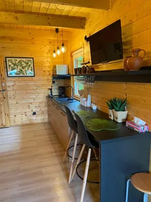 a kitchen with a table and a sink in a cabin at Bacówka na Leśnej in Po”łwieś