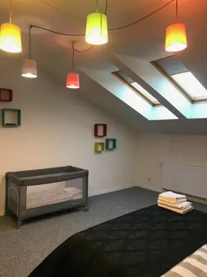 a room with a bed and lights on the ceiling at Klimatyczny apartament przy bocheńskim Rynku. in Bochnia