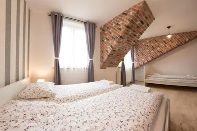 a bedroom with a large bed and a large window at Fresh Apartments in Kraków