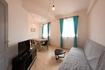 a living room with a bed and a table at Fresh Apartments in Kraków