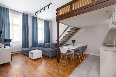 a living room with a couch and a table at Fresh Apartments in Kraków