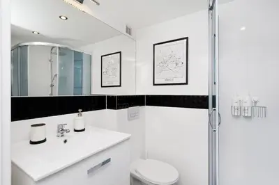 a white bathroom with a sink and a shower at Dietla 99 - Studio by Homeprime in Kraków