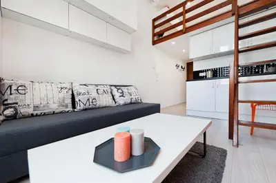 a living room with a couch and a table at Dietla 99 - Studio by Homeprime in Kraków