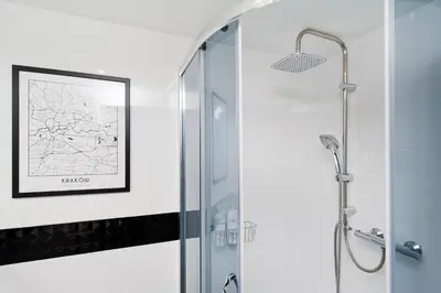 a shower with a glass door in a bathroom at Dietla 99 - Studio by Homeprime in Kraków