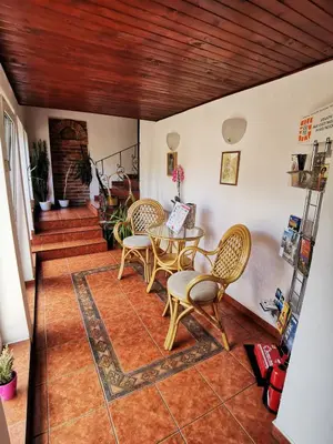 a living room with a table and chairs at Dom pod Tujami in Kraków