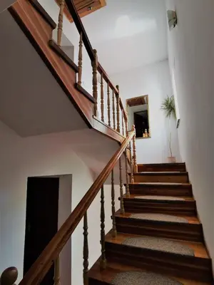 a staircase in a house with wooden railings at Dom pod Tujami in Kraków