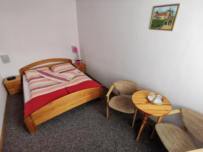 a bedroom with a bed and a table and chairs at Dom pod Tujami in Kraków