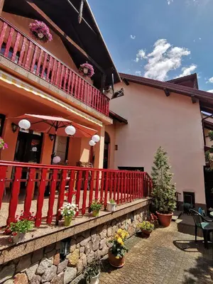 a house with a red railing and a patio at Dom pod Tujami in Kraków