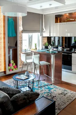 a kitchen and living room with a couch and a table at AGA Tenis Apartments by Radwańska in Kraków
