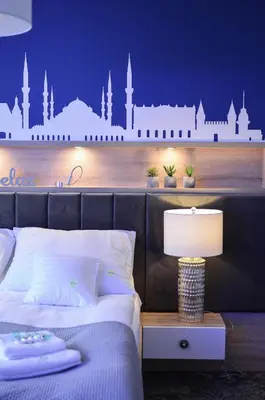 a bedroom with a bed with a city mural on the wall at AGA Tenis Apartments by Radwańska in Kraków