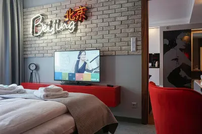a bedroom with a bed and a tv on a brick wall at AGA Tenis Apartments by Radwańska in Kraków