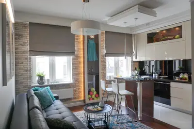a living room with a couch and a kitchen at AGA Tenis Apartments by Radwańska in Kraków