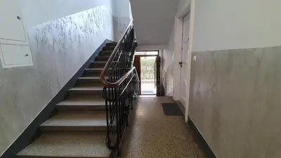 a staircase in a house with a metal railing at Krakow 360 Apartment in Kraków
